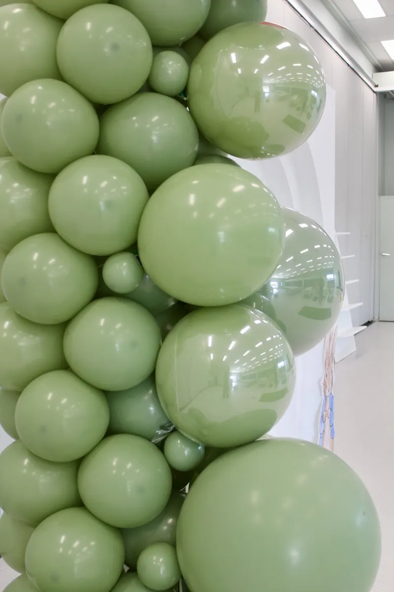 Close-up of an organic garland of sage balloons in mixed sizes