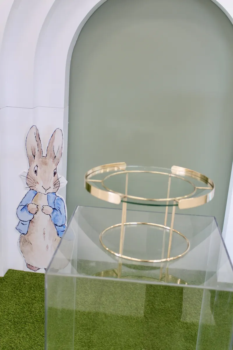 Gold cake stand on a clear acrylic plinth
