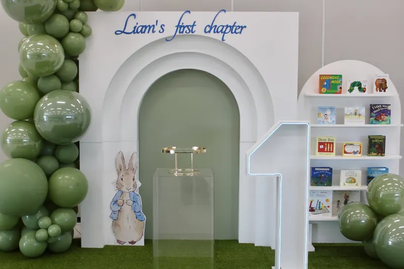 Full storybook set-up with balloon garland, arch, lettering and bookshelf